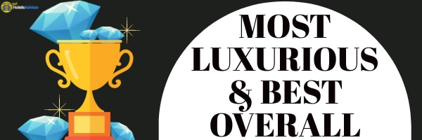 Illustration of a golden trophy surrounded by blue diamonds with the text "Most Luxurious & Best Overall" in bold black letters on a white background, reflecting the opulence found in Jamaica hotels.