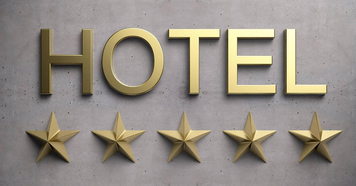 Five gold stars representing hotel star ratings on a concrete background.