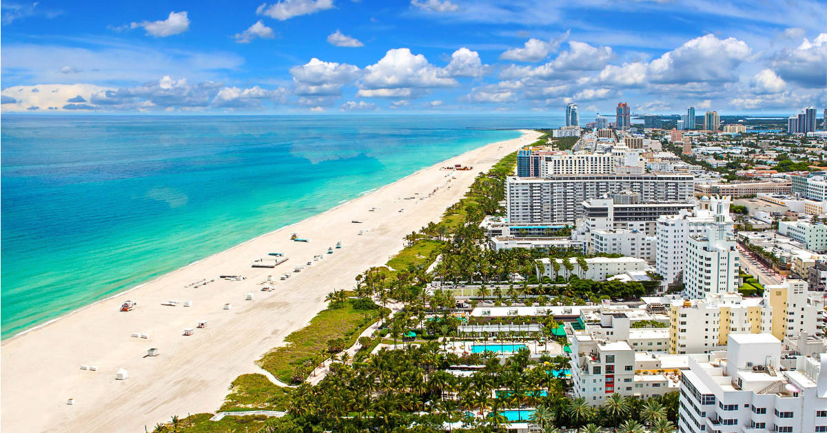 A beach with buildings and palm trees in FLORIDA.