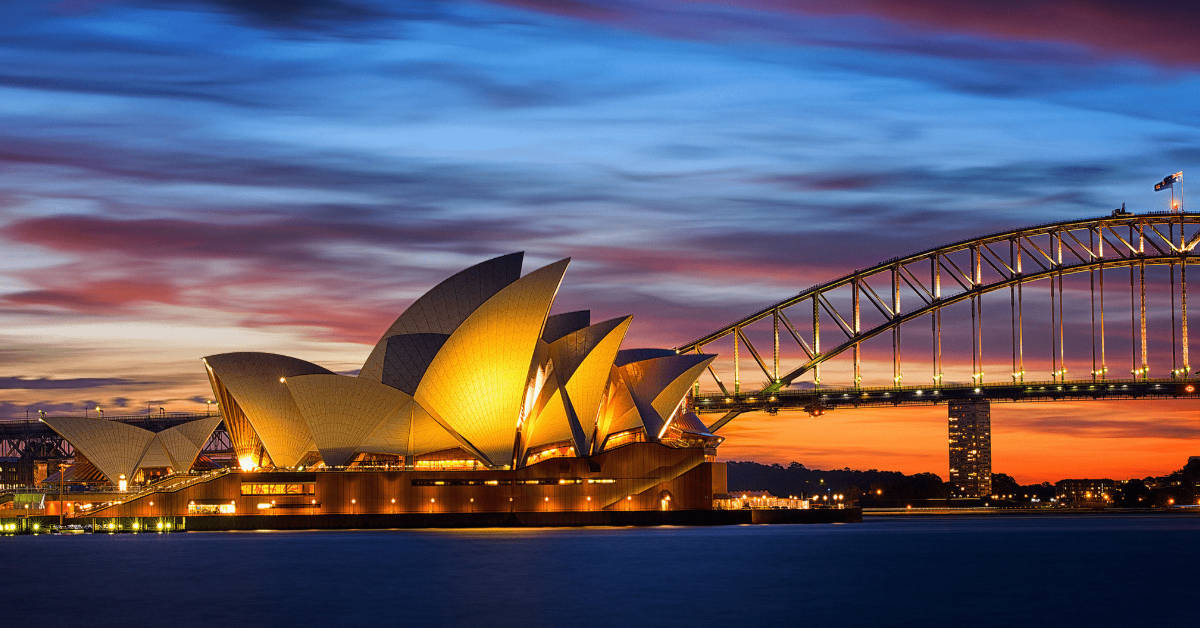 A bridge over water with a building and a hotel.